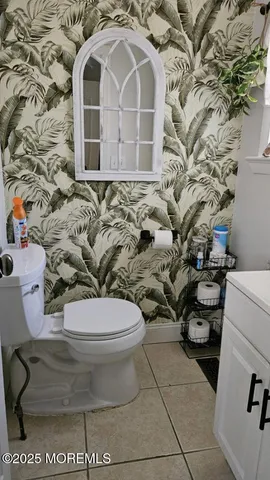 a toilet sitting next to a shower curtain
