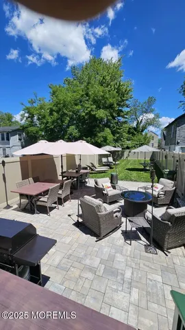 a view of backyard with seating area and green space