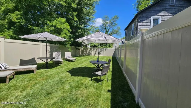 a view of a chair and table under an umbrella