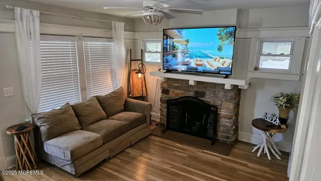 a living room with furniture a flat screen tv and a fireplace