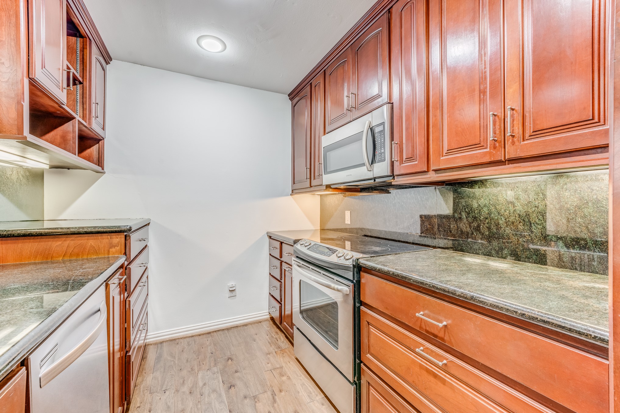 708 Fowler Street Houston, TX 77007 - Photo 34 of 42 a kitchen with granite countertop cabinets stainless steel appliances and a counter space