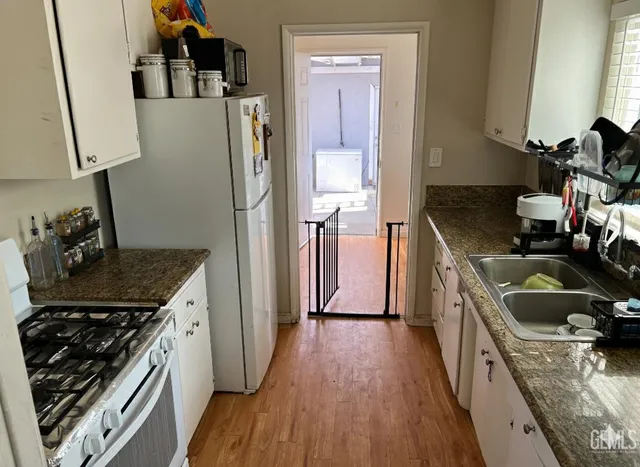 a kitchen with a stove a refrigerator and a sink