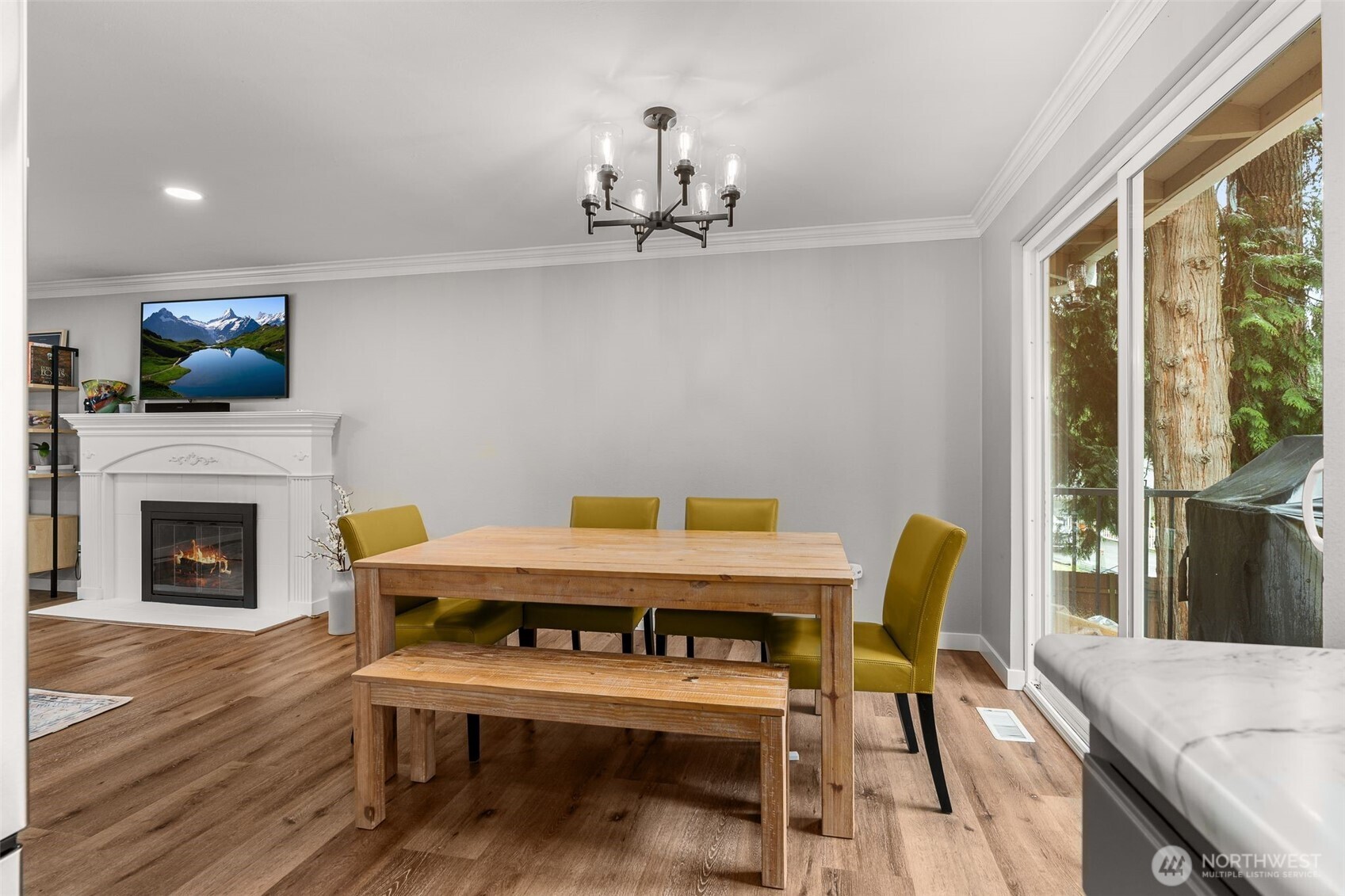1128 203rd Place Southeast Bothell, WA 98012 - Photo 12 of 38 a view of a dining room with furniture a fireplace and wooden floor