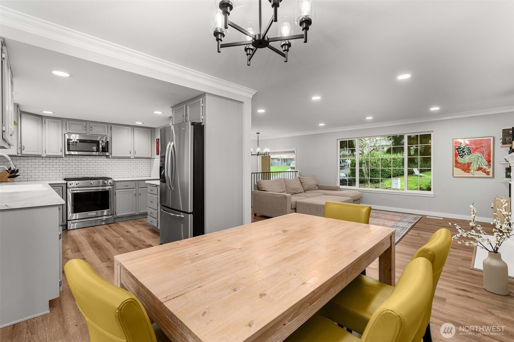 1128 203rd Place Southeast Bothell, WA 98012 - Photo 14 of 38 a large kitchen with kitchen island a stove a sink a dining table and chairs