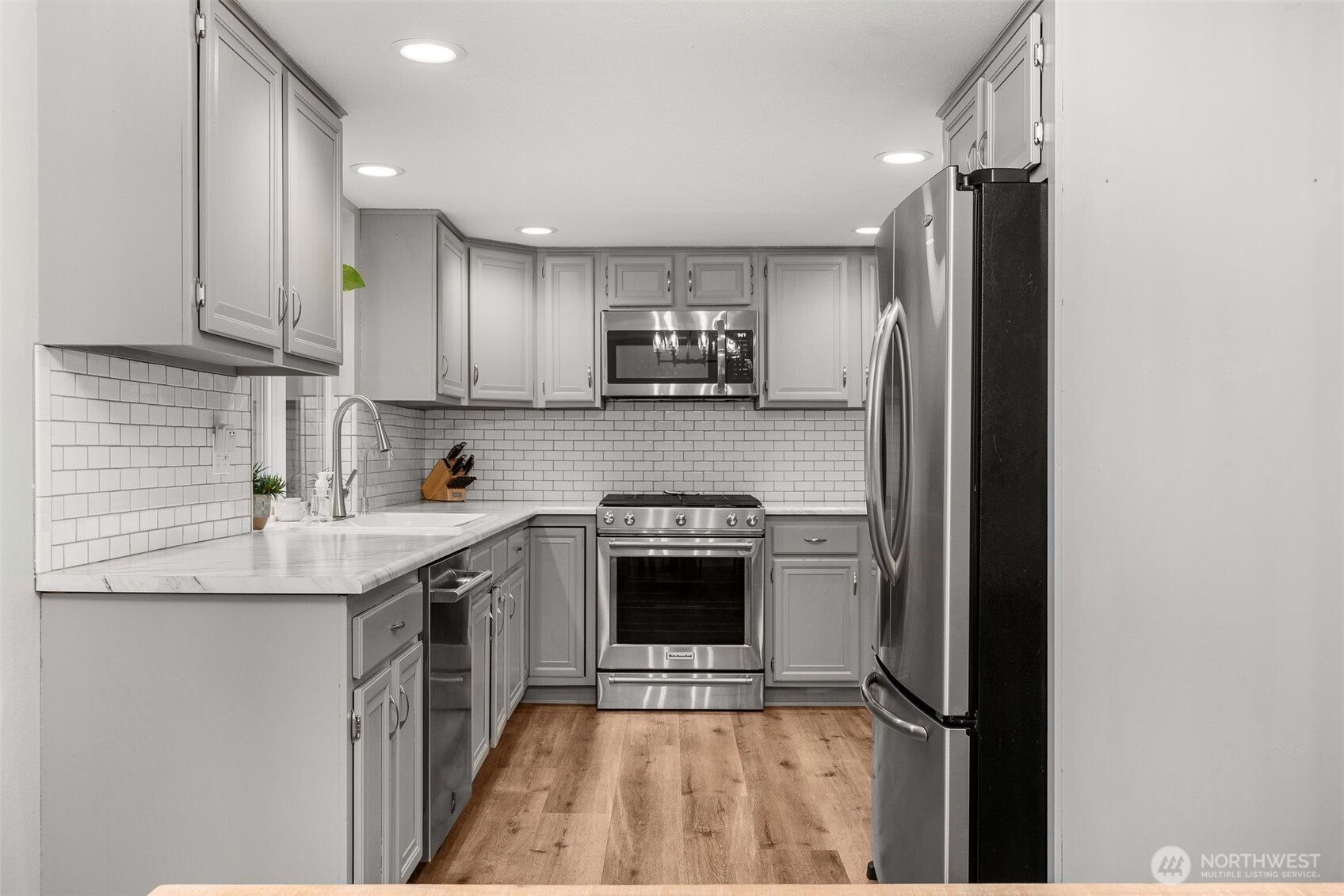 1128 203rd Place Southeast Bothell, WA 98012 - Photo 15 of 38 a kitchen with stainless steel appliances granite countertop a stove top oven a sink and a refrigerator