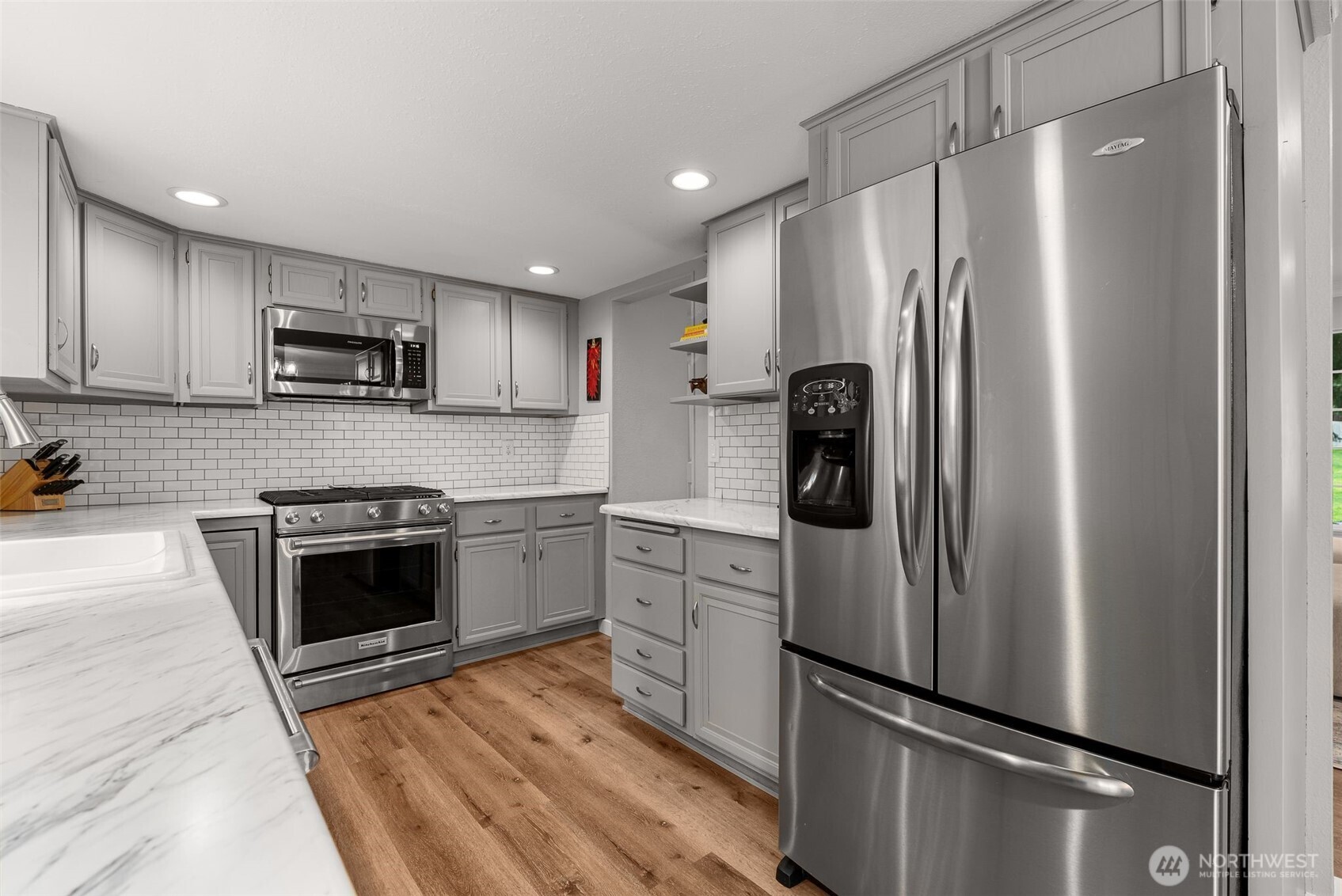 1128 203rd Place Southeast Bothell, WA 98012 - Photo 16 of 38 a kitchen with stainless steel appliances granite countertop a refrigerator and a stove top oven