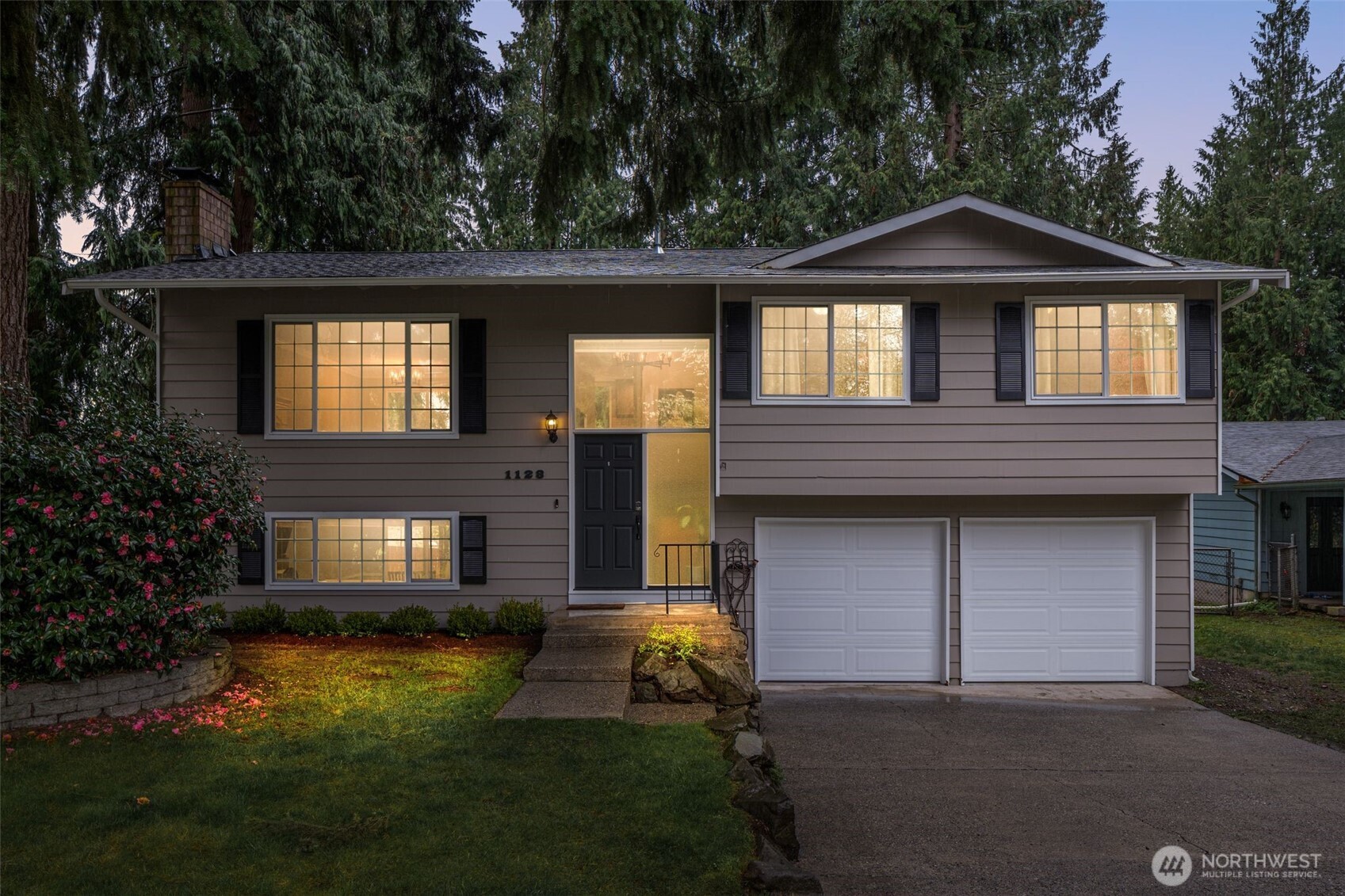 1128 203rd Place Southeast Bothell, WA 98012 - Photo 2 of 38 a front view of a house with garden