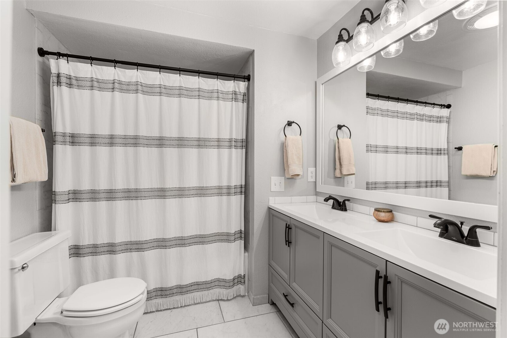 1128 203rd Place Southeast Bothell, WA 98012 - Photo 26 of 38 a bathroom with a sink a toilet and shower