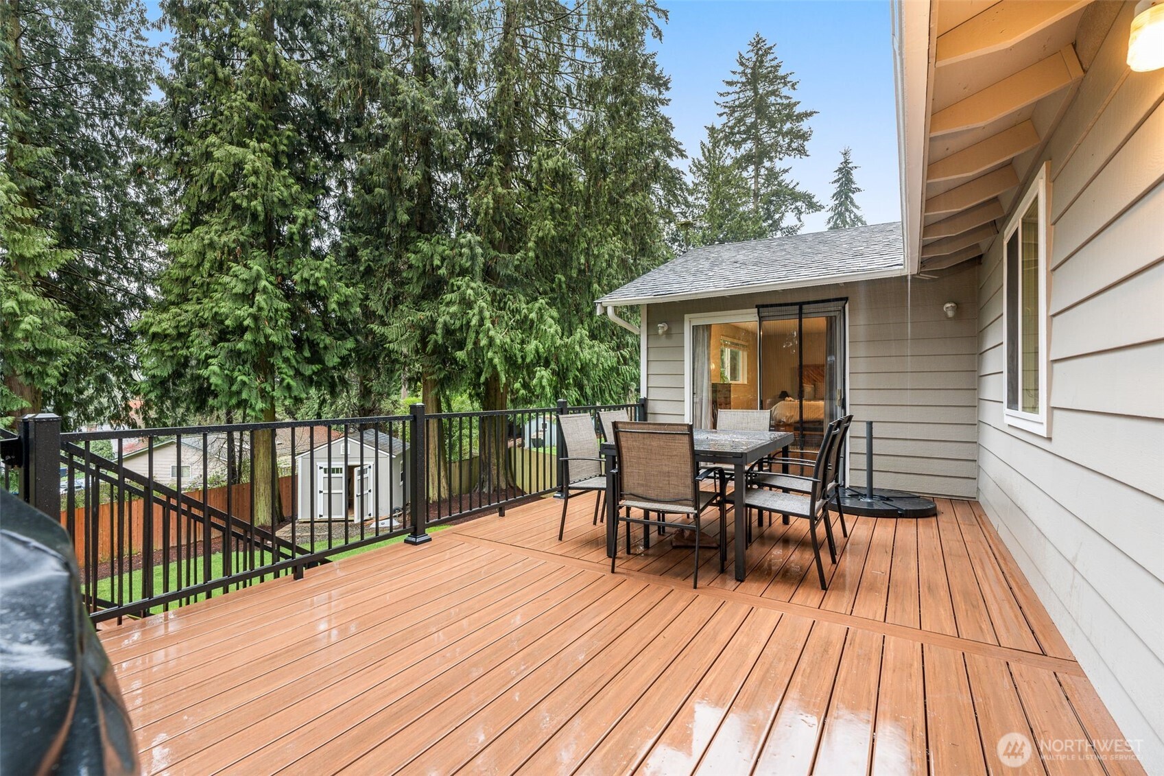 1128 203rd Place Southeast Bothell, WA 98012 - Photo 31 of 38 a view of a roof deck with table and chairs floor to ceiling window with wooden floor