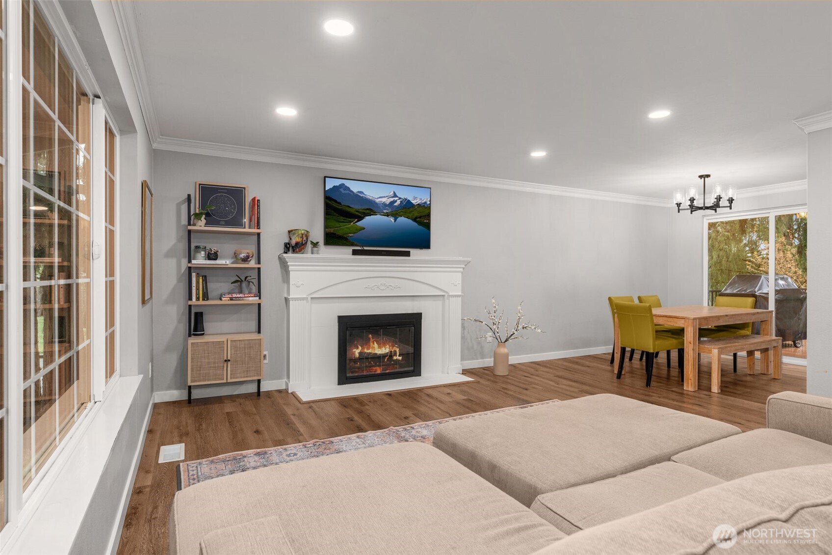1128 203rd Place Southeast Bothell, WA 98012 - Photo 10 of 38 a living room with furniture a fireplace and a flat screen tv