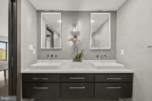 a bathroom with a sink vanity and a mirror