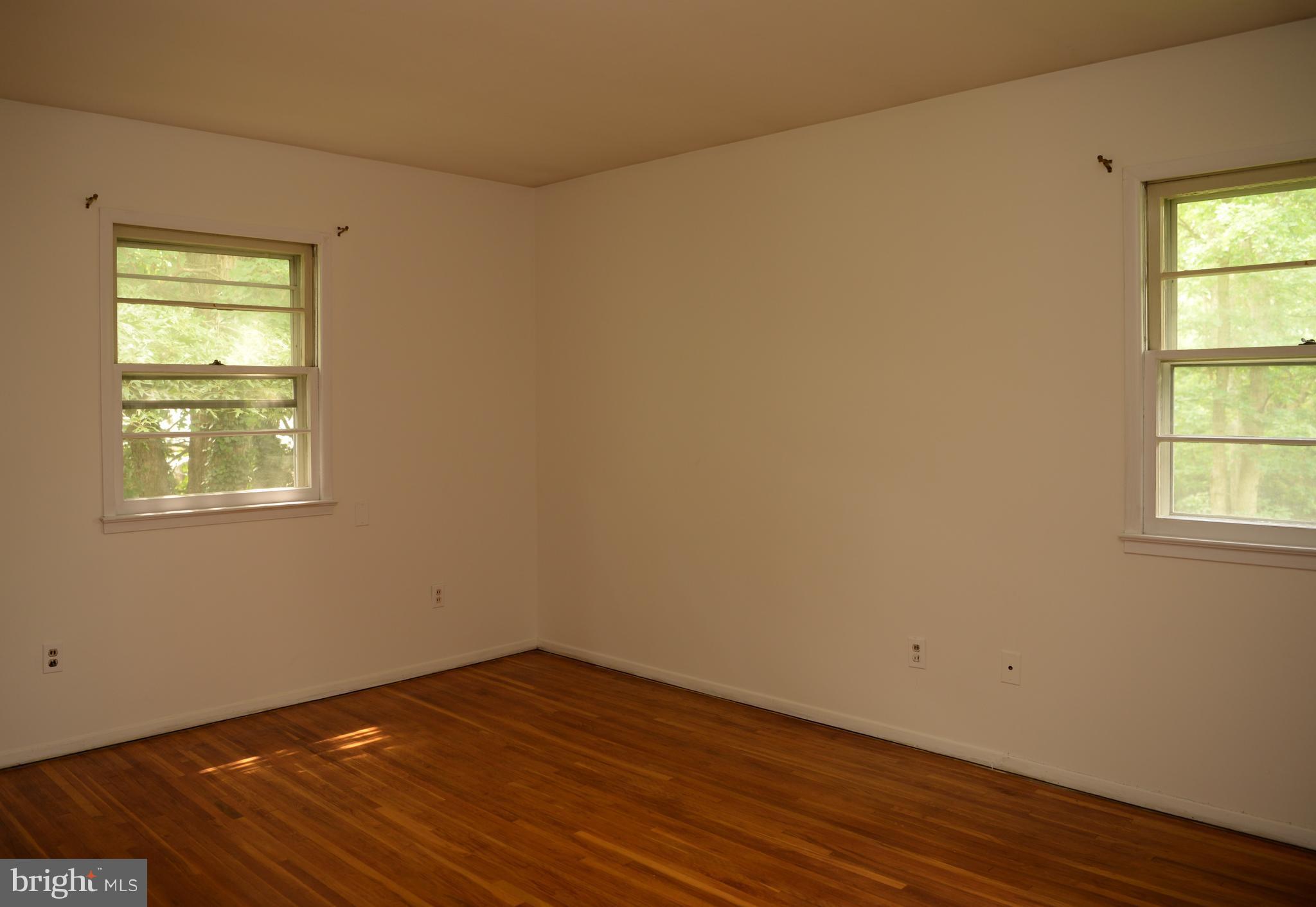 6427 Pima Street Alexandria, VA 22312 - Photo 11 of 30 an empty room with wooden floor and windows