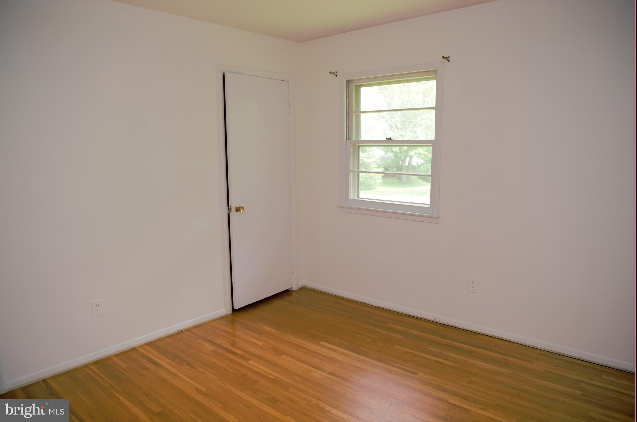 6427 Pima Street Alexandria, VA 22312 - Photo 14 of 30 an empty room with wooden floor and windows