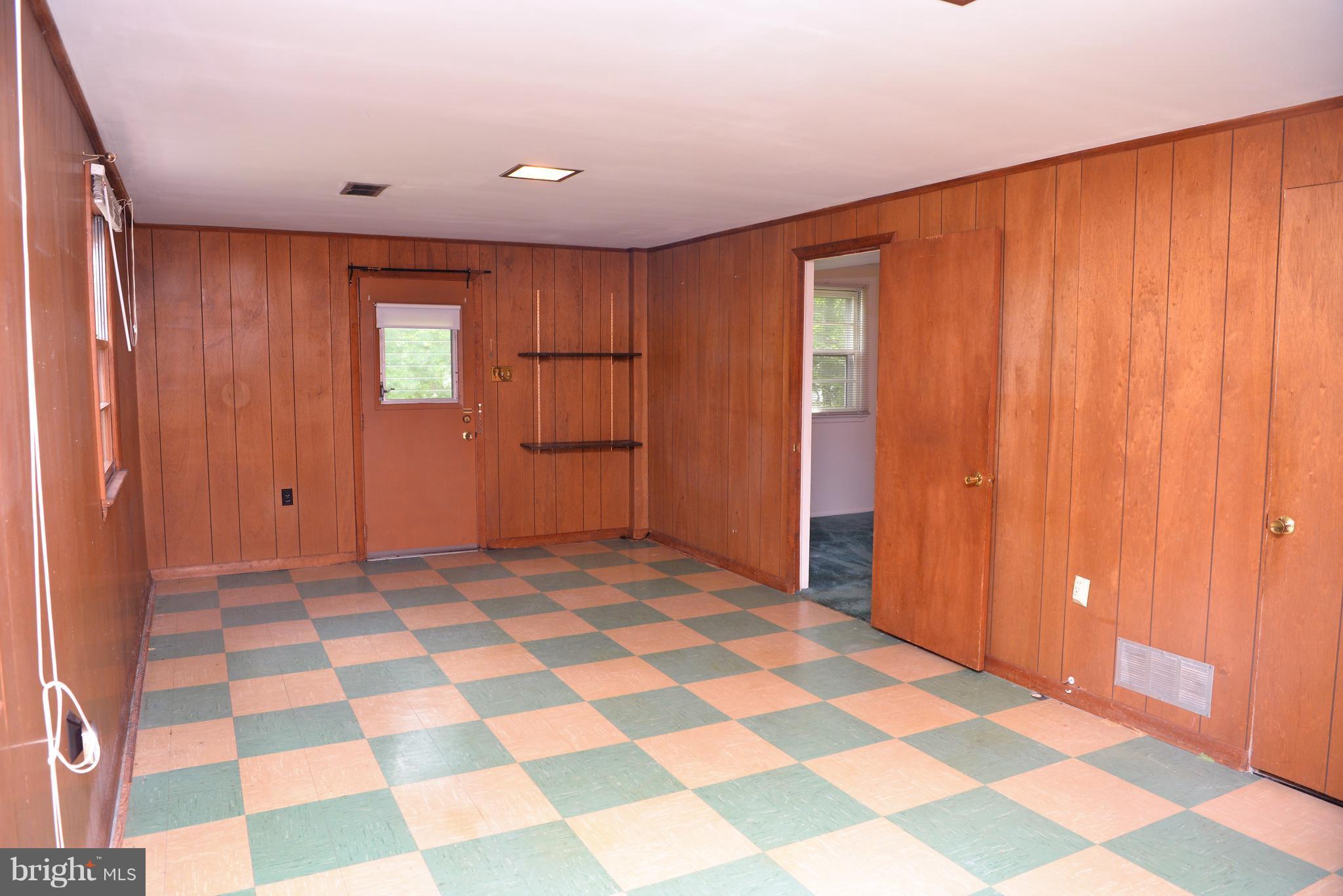 6427 Pima Street Alexandria, VA 22312 - Photo 17 of 30 a view of a livingroom with a black and white checkered floor with a black white checkered floor