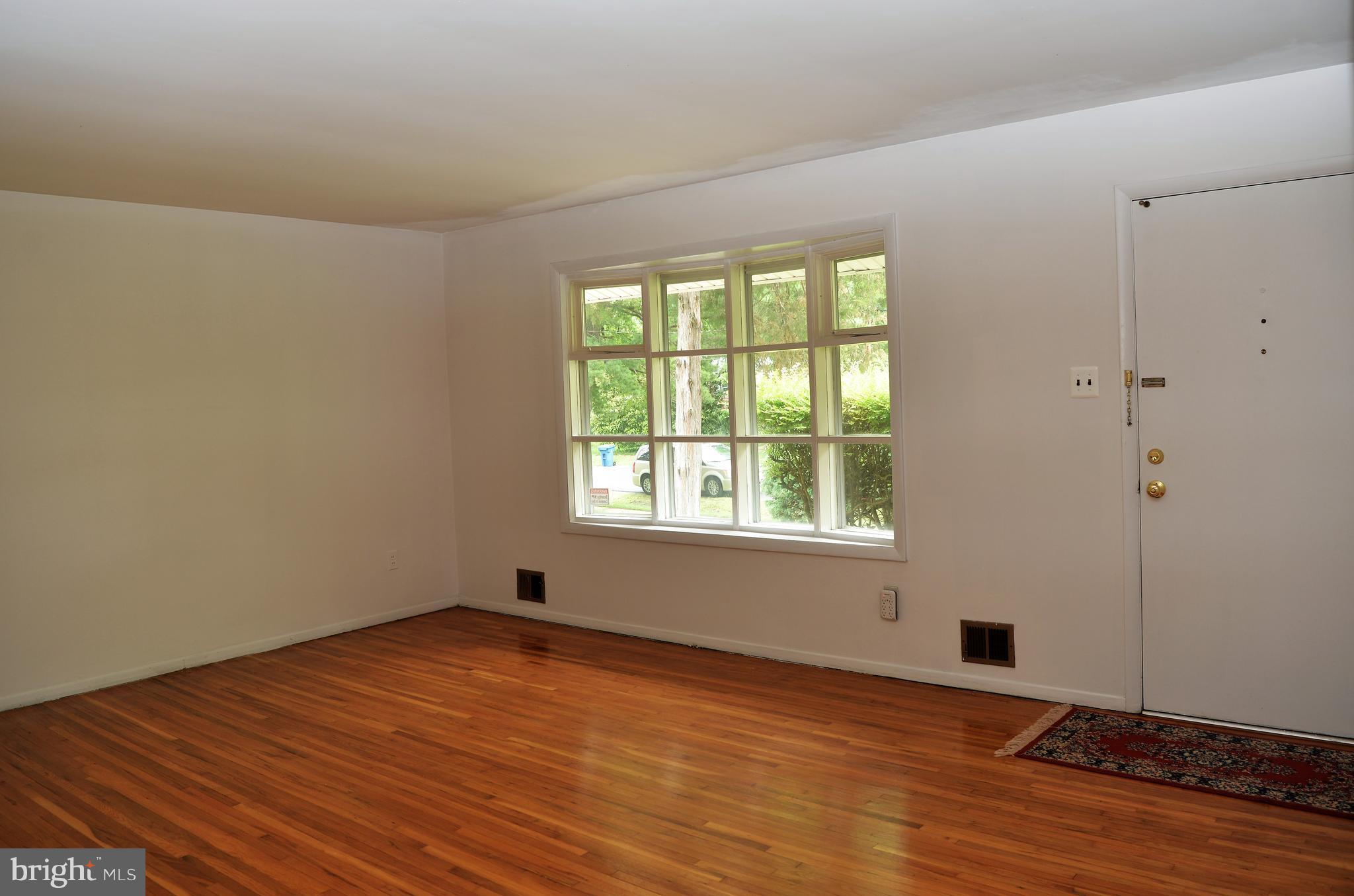 6427 Pima Street Alexandria, VA 22312 - Photo 3 of 30 a view of empty room with wooden floor and fan