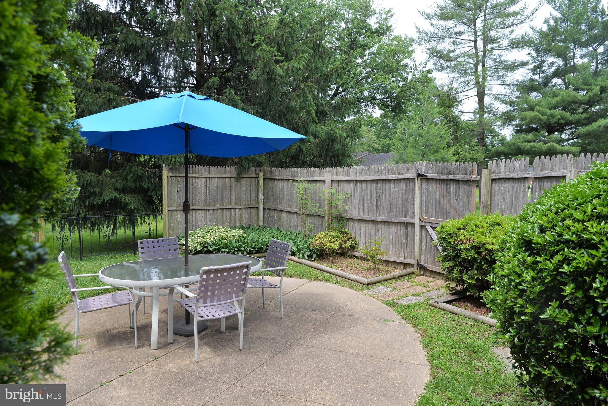 6427 Pima Street Alexandria, VA 22312 - Photo 21 of 30 a view of a table and chair under an umbrella in the patio