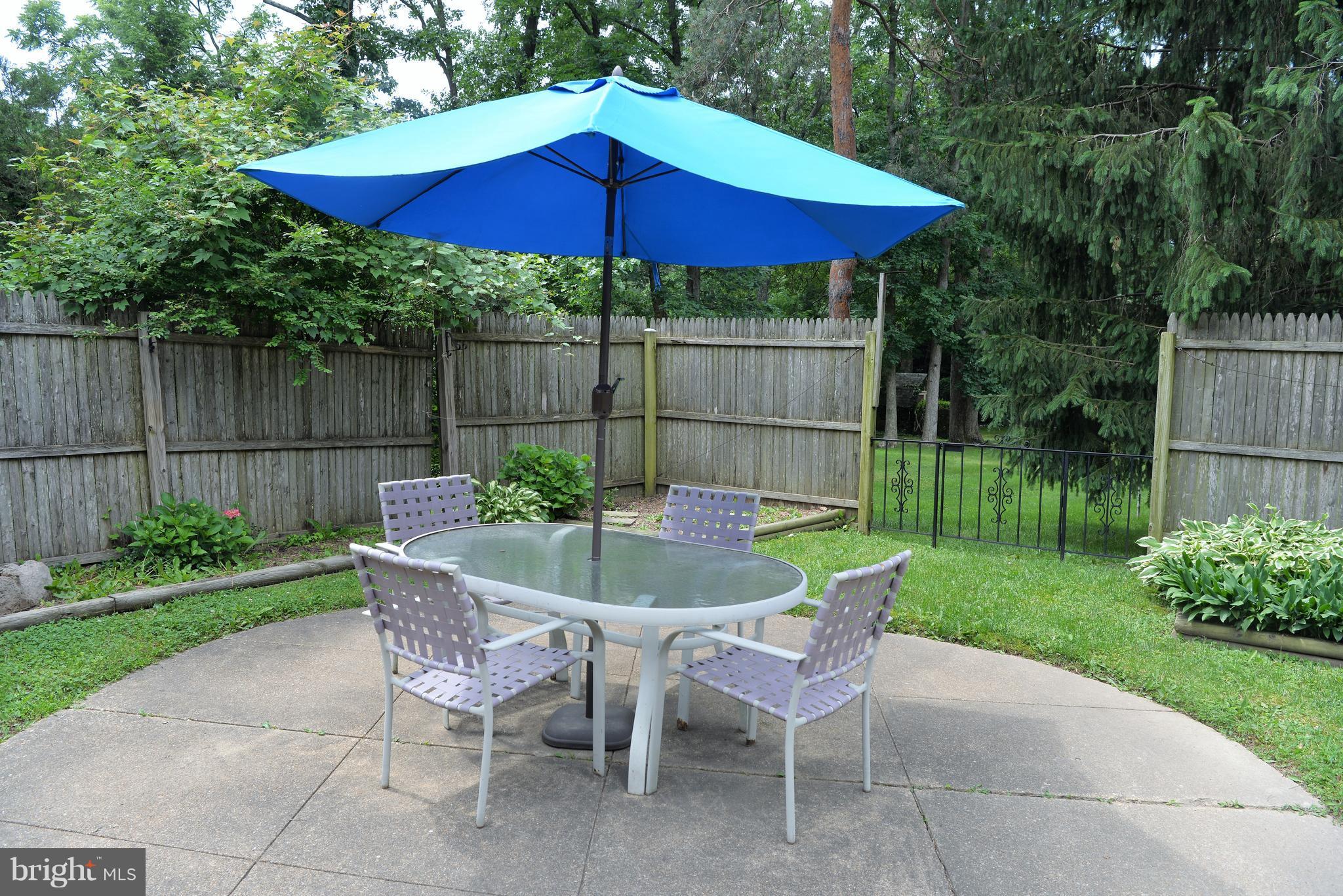 6427 Pima Street Alexandria, VA 22312 - Photo 22 of 30 a view of a chair and table under an umbrella