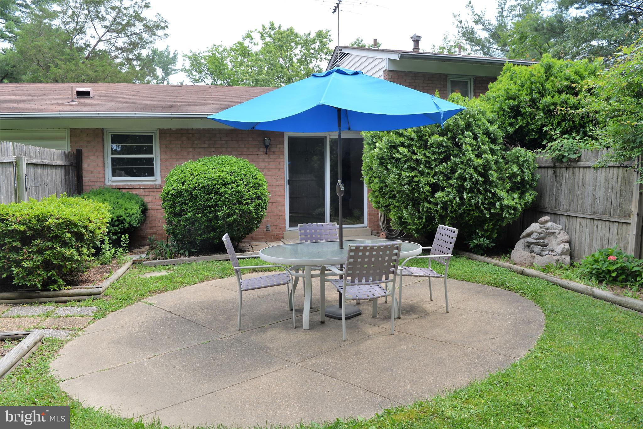6427 Pima Street Alexandria, VA 22312 - Photo 23 of 30 a view of a house with a yard and sitting area