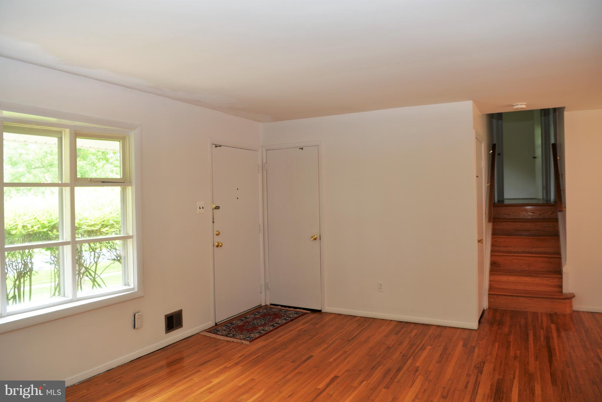 6427 Pima Street Alexandria, VA 22312 - Photo 4 of 30 a view of an empty room with wooden floor and a window