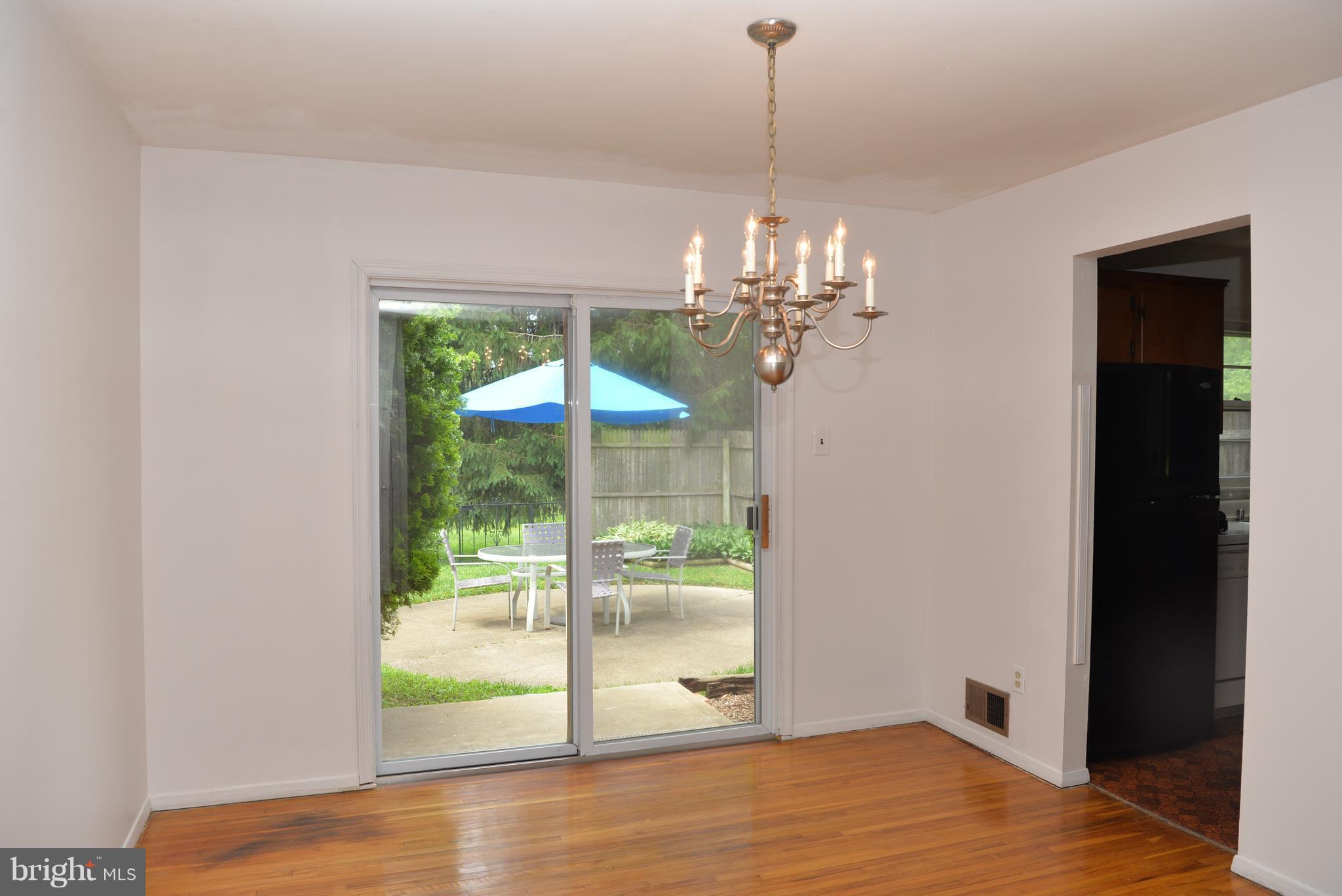 6427 Pima Street Alexandria, VA 22312 - Photo 6 of 30 a view of a room with wooden floor outdoor seating and yard