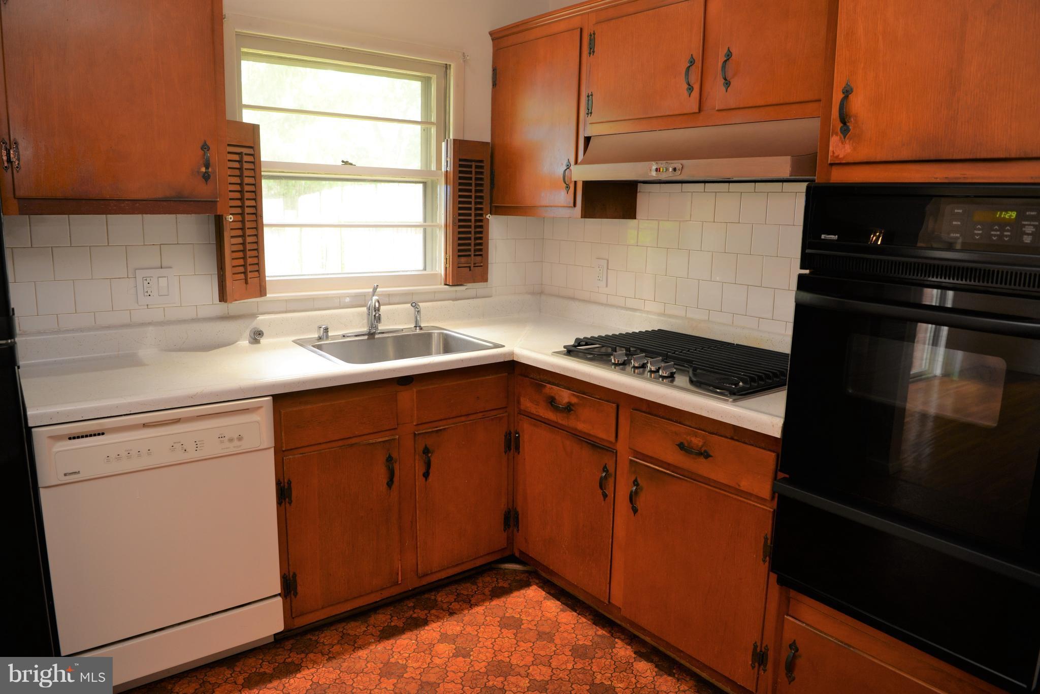 6427 Pima Street Alexandria, VA 22312 - Photo 7 of 30 a kitchen with granite countertop cabinets stainless steel appliances and a window