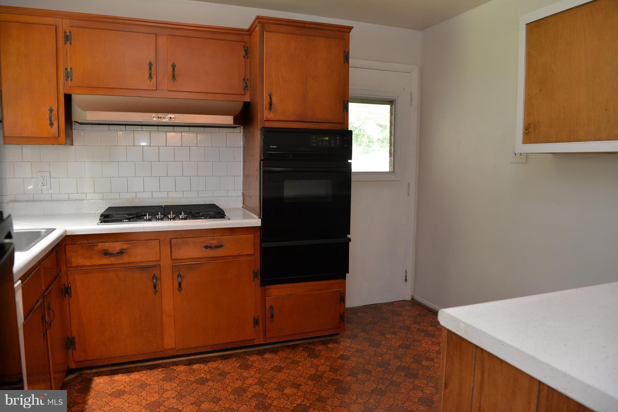6427 Pima Street Alexandria, VA 22312 - Photo 8 of 30 a kitchen with granite countertop cabinets and refrigerator