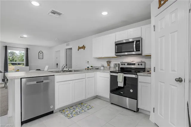 a kitchen with sink cabinets and stainless steel appliances