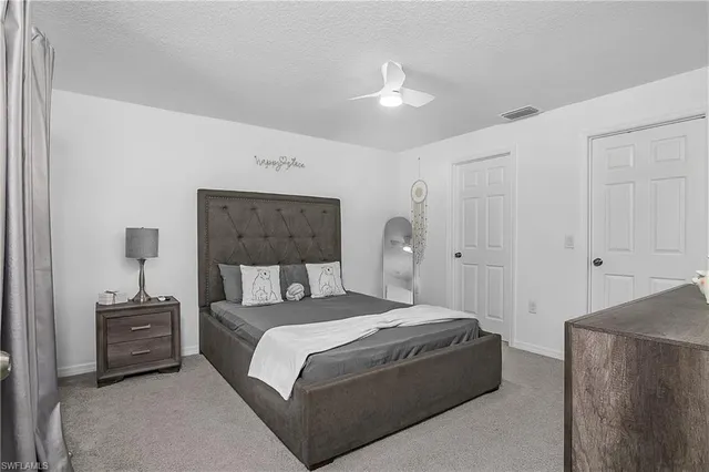 a bathroom with a granite countertop double vanity sink and a mirror