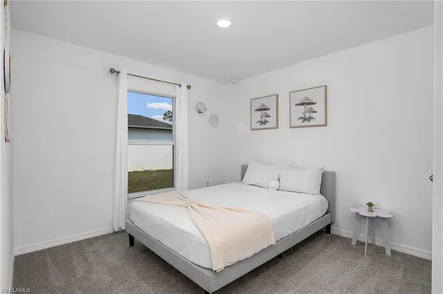 a bathroom with a granite countertop toilet a sink and a mirror