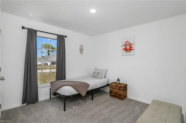 a bedroom with a bed and a table