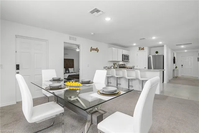 a kitchen with a dining table chairs and view kitchen
