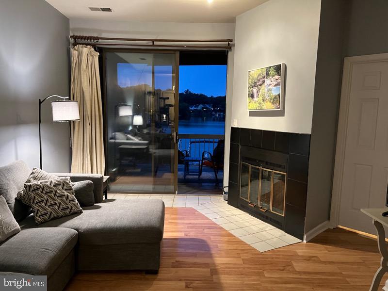 11166 Harbor Court, Unit 1166 Reston, VA 20191 - Photo 2 of 4 a living room with furniture and a fireplace