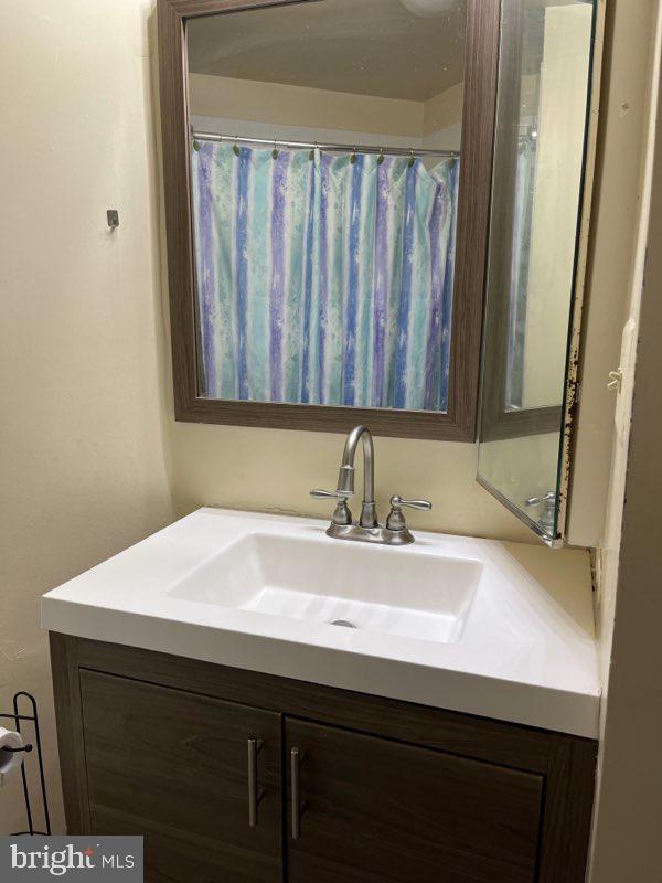 11166 Harbor Court, Unit 1166 Reston, VA 20191 - Photo 4 of 4 a bathroom with a sink and a mirror
