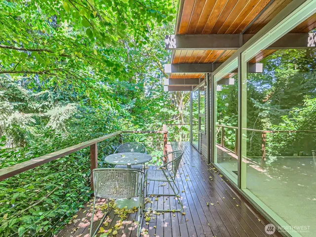 a view of a balcony with floor to ceiling windows with wooden floor