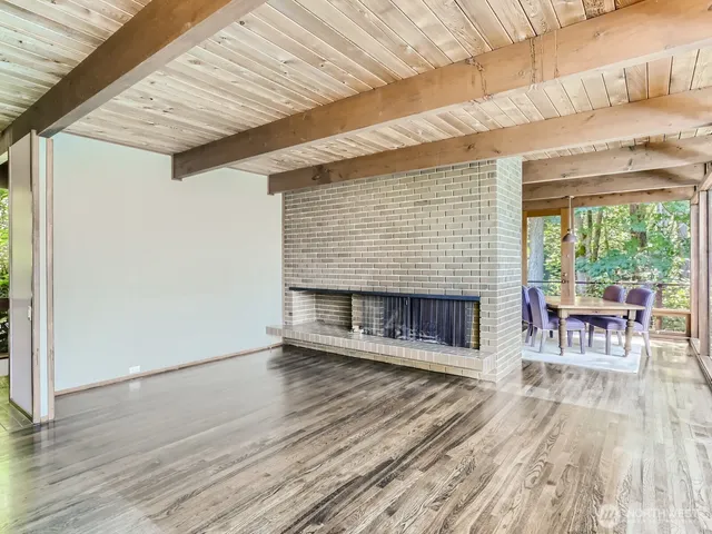 a view of a patio with table and chairs floor to ceiling window with wooden floor
