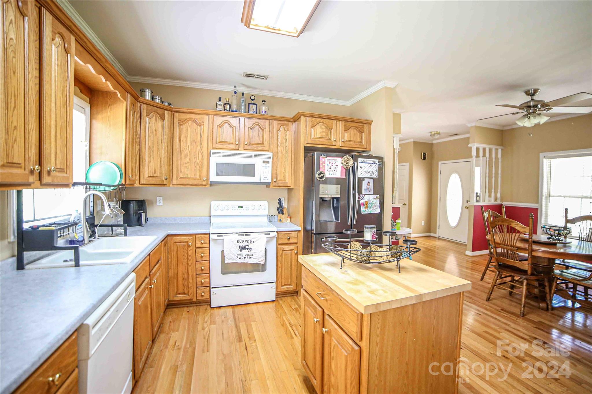 1117 Blacksnake Road Stanley, NC 28164 - Photo 8 of 27 a kitchen with a sink a counter top space and living room view