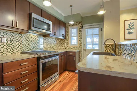 a kitchen with a stove a sink and a microwave