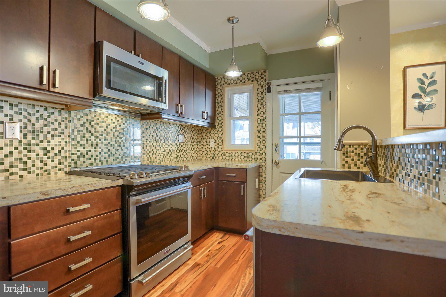 2616 Liberty Parkway Baltimore, MD 21222 - Photo 12 of 41 a kitchen with a stove a sink and a microwave