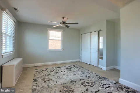 a view of a room with a window and wooden floor