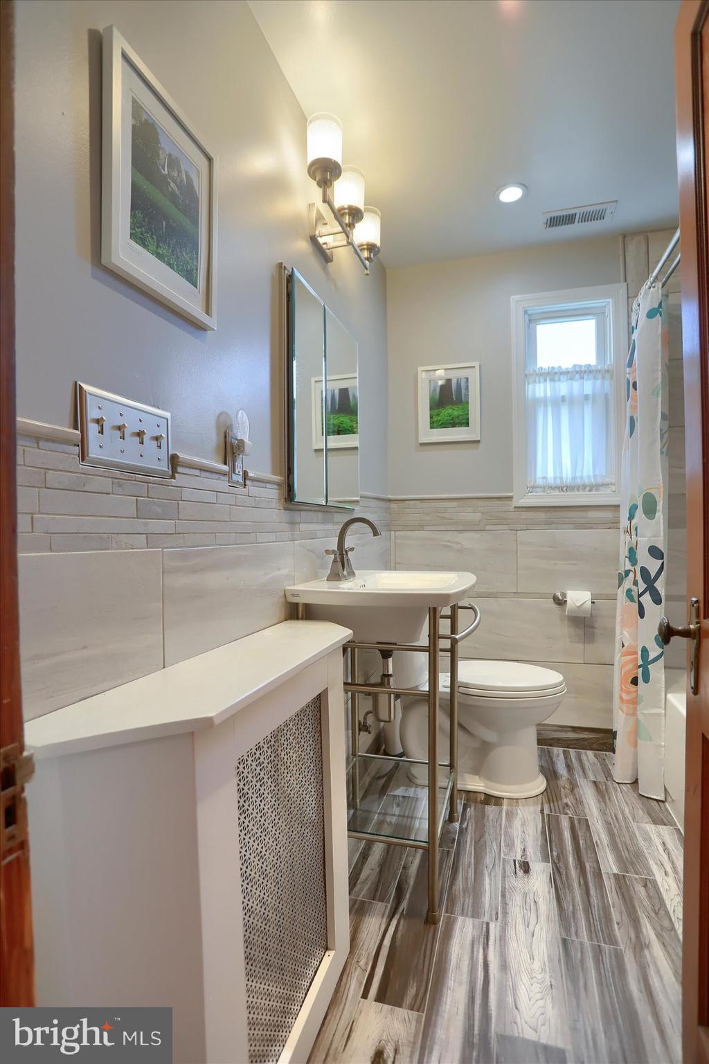 2616 Liberty Parkway Baltimore, MD 21222 - Photo 18 of 41 a bathroom with a sink a toilet and a mirror