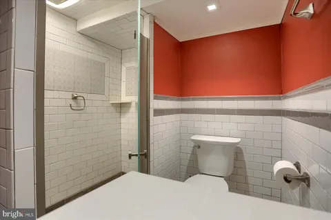 a bathroom with a toilet and shower