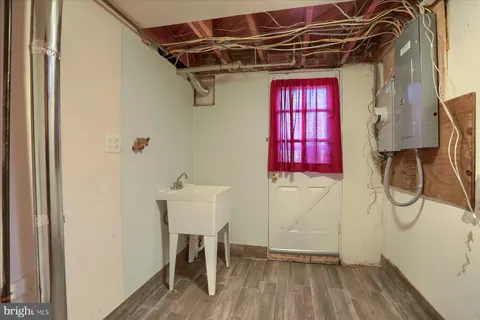 a view of a room with red door and wooden floor