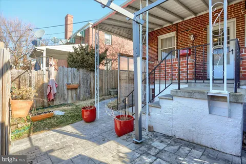 a view of a patio with table and chairs and potted plants