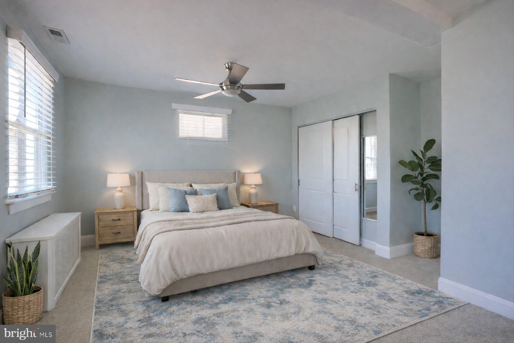 2616 Liberty Parkway Baltimore, MD 21222 - Photo 5 of 41 a bedroom with a large bed and a potted plant