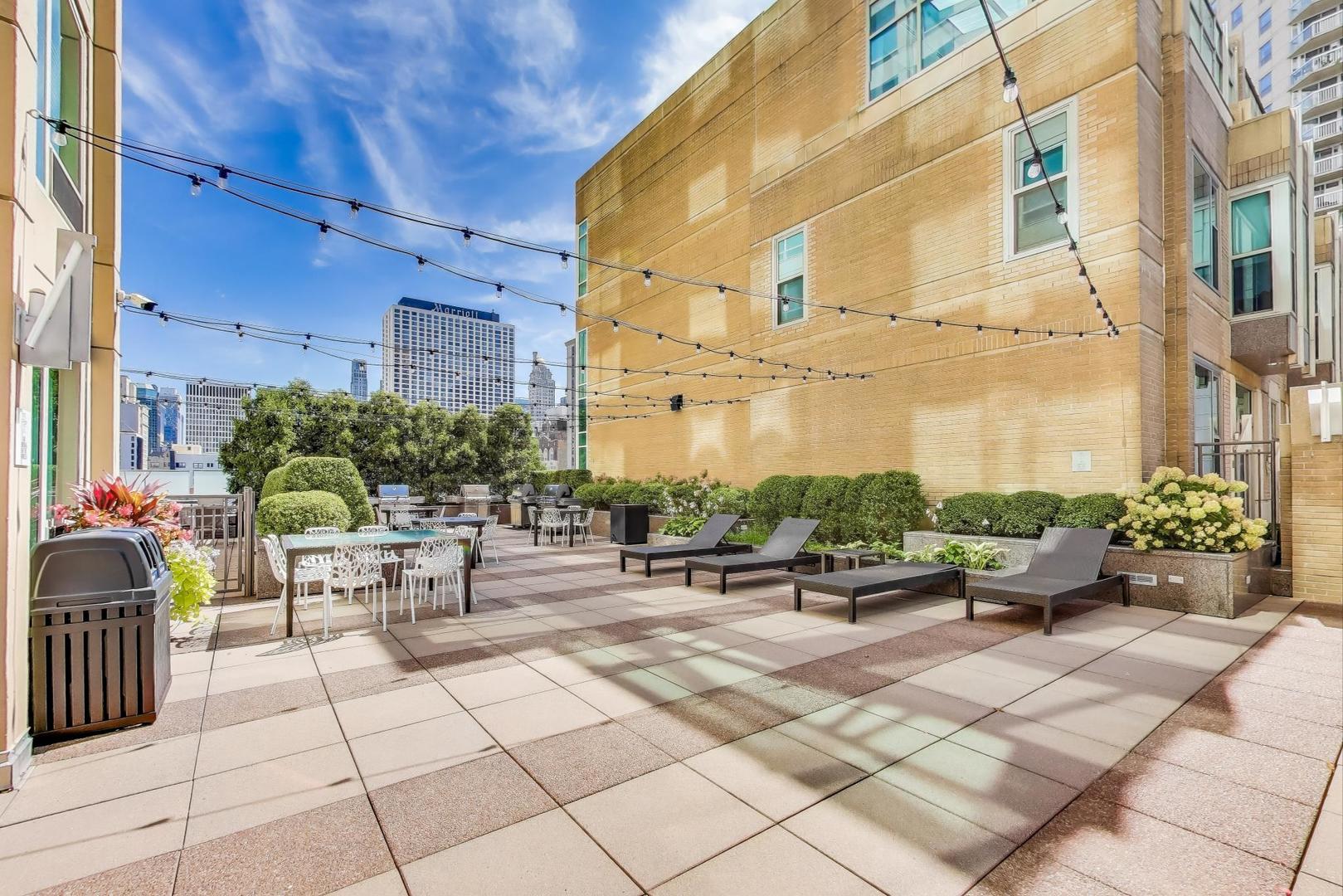 33 West Ontario Street, Unit 46C Chicago, IL 60654 - Photo 26 of 32 a view of a patio with dining table and chairs