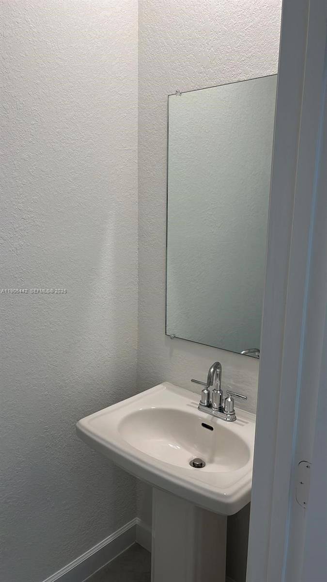606 Southwest 12th Avenue Homestead, FL 33030 - Photo 18 of 20 a bathroom with a sink and a mirror