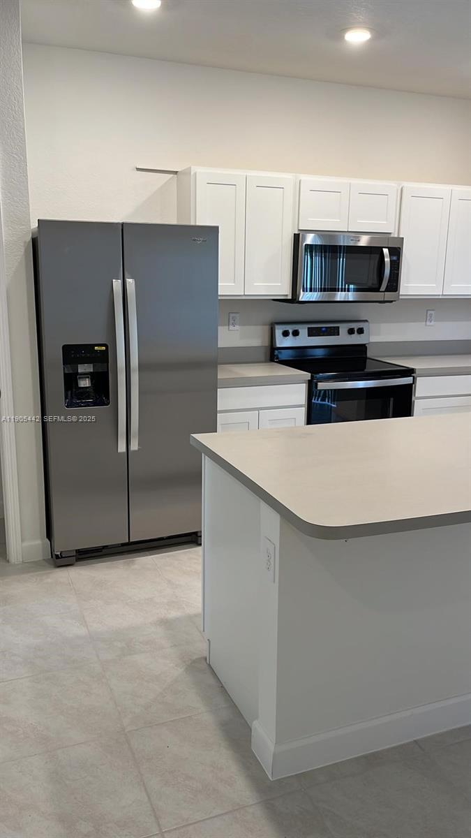 606 Southwest 12th Avenue Homestead, FL 33030 - Photo 10 of 20 a kitchen with stainless steel appliances a refrigerator and a stove