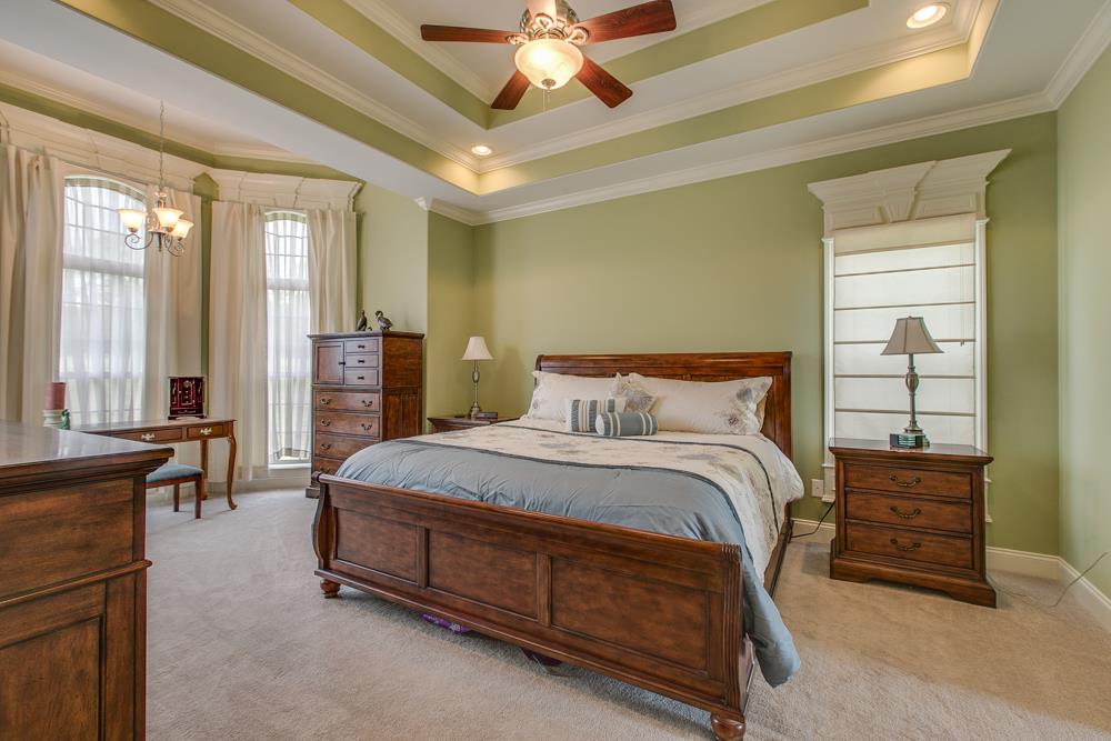 4703 Alsup Mill Road Lascassas, TN 37085 - Photo 15 of 30 a spacious bedroom with a bed a chandelier and a dresser