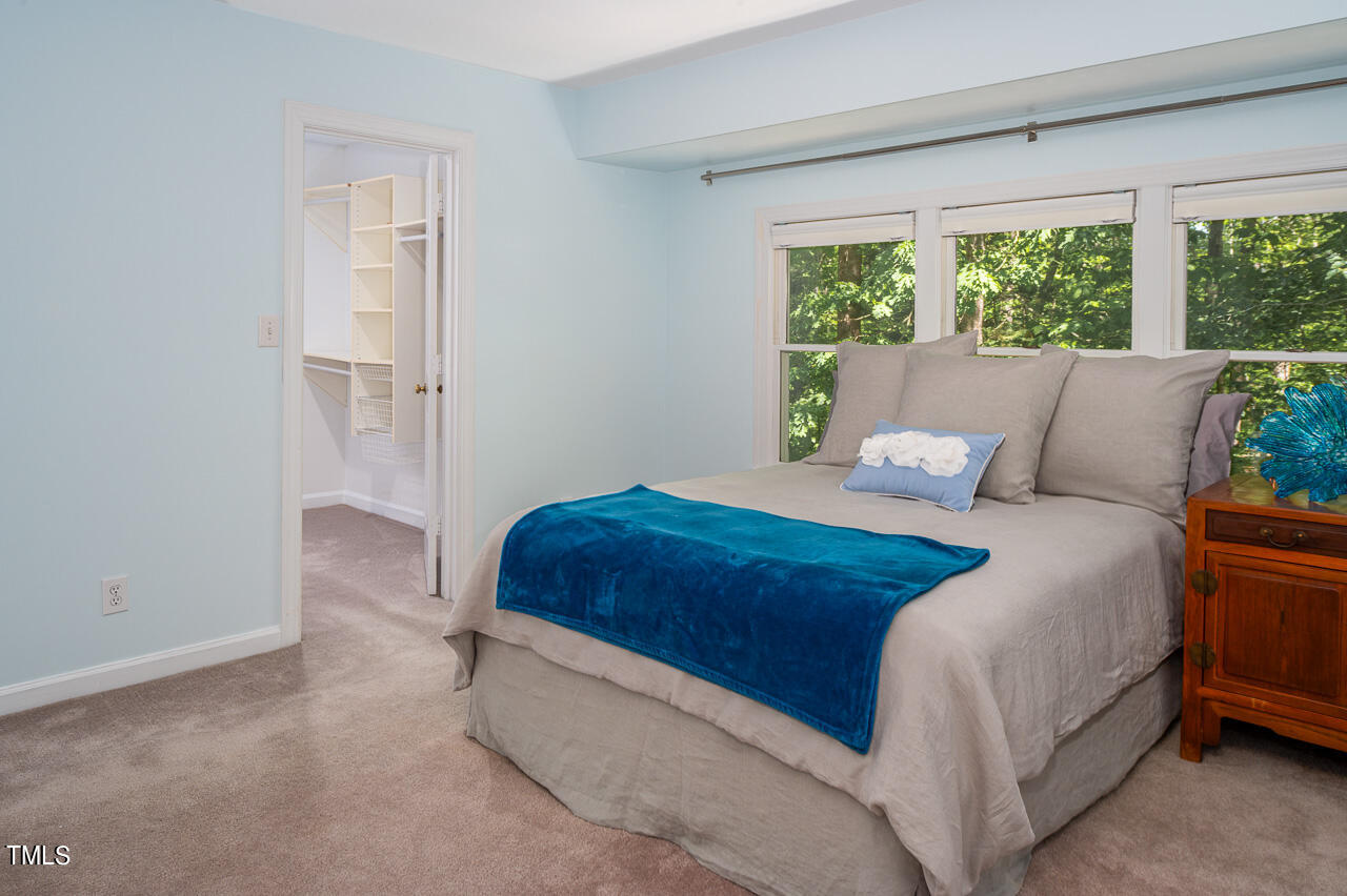 479 Beechmast Pittsboro, NC 27312 - Photo 16 of 22 a bedroom with a bed and a large window