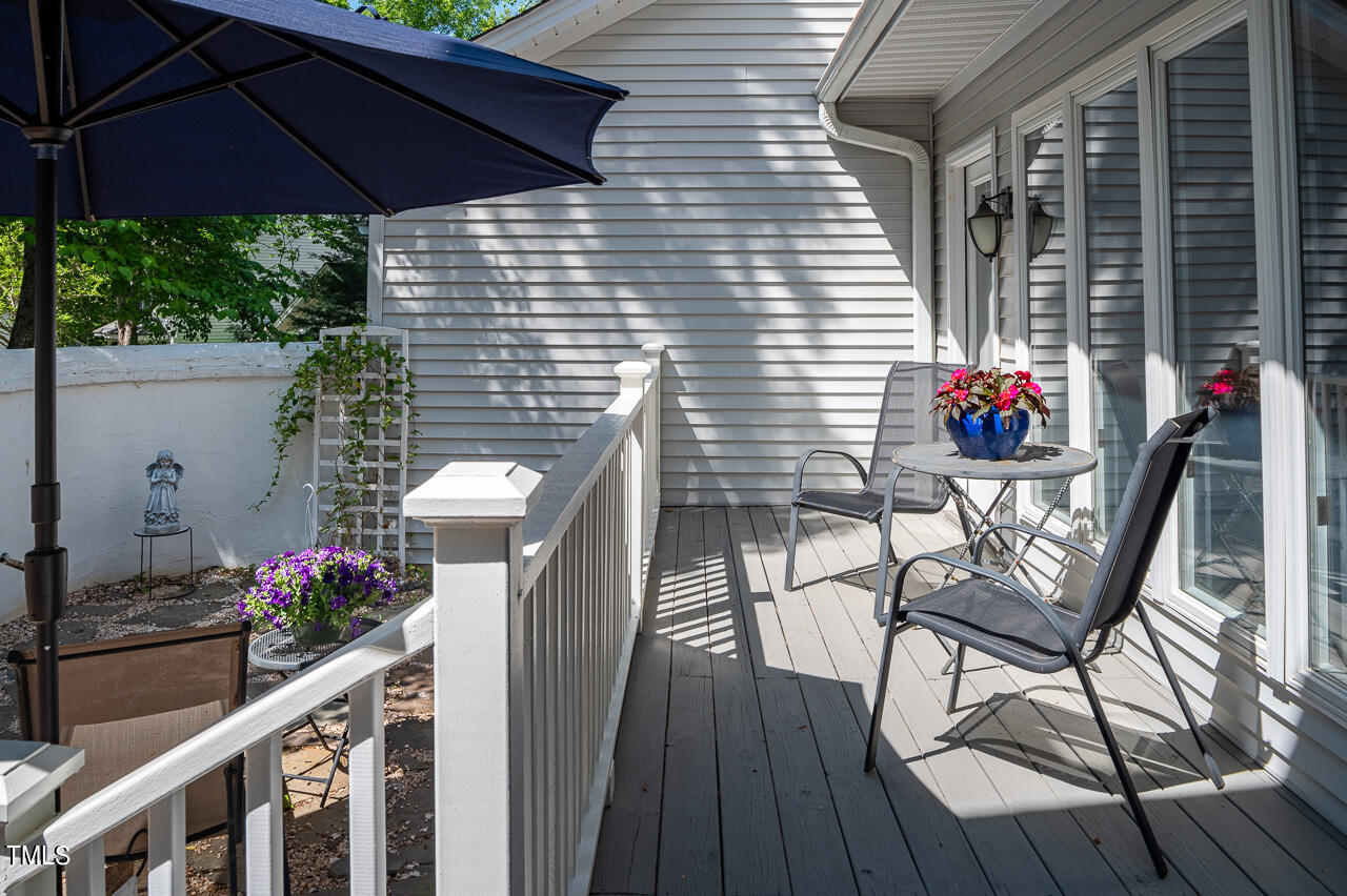 479 Beechmast Pittsboro, NC 27312 - Photo 3 of 22 a view of a balcony with chairs potted plants and wooden floor